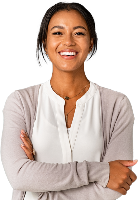 Smiling woman with dark hair in a white blouse and light cardigan, standing with arms crossed in Los Angeles.