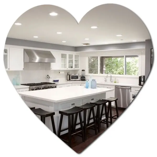 Modern white kitchen with island, black stools, and stained wood accents in a heart-shaped frame—Los Angeles style.
