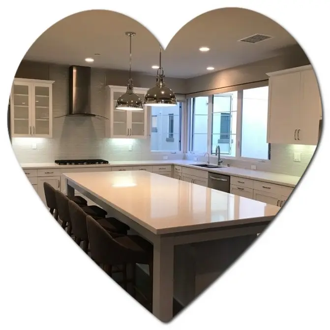 Modern kitchen with a cabinet refresh and large island, viewed through a heart-shaped frame.
