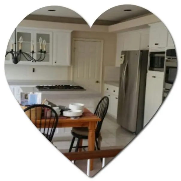 Heart-shaped frame showing a modern white kitchen with appliances, table, chairs, and a cabinet refresh.
